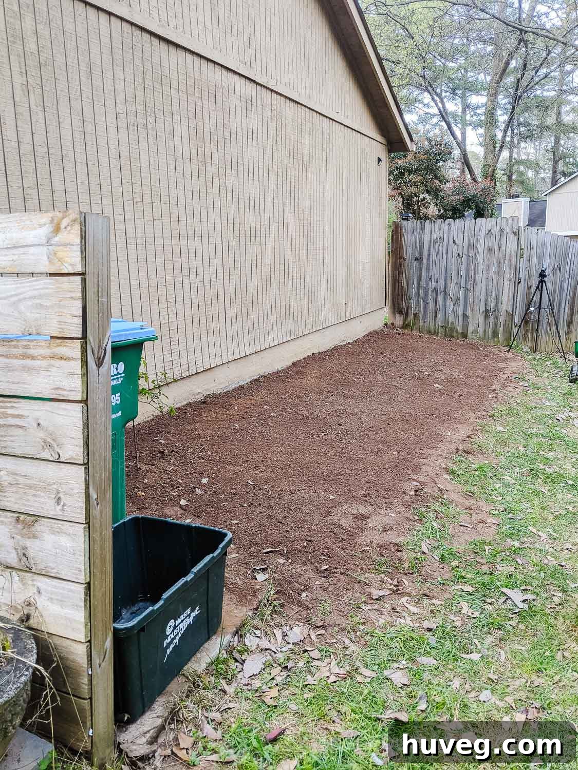 Breaking up and preparing the soil on the side of the house in preparation for a new garden.