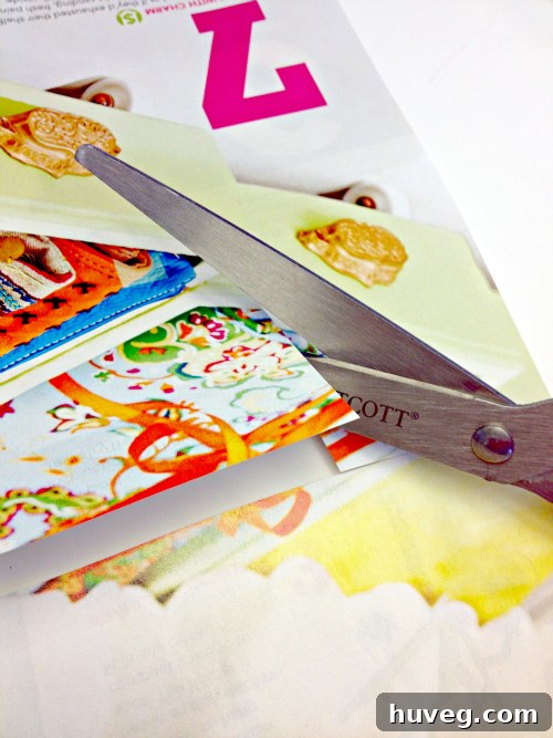 Cutting diverse raindrop shapes from magazine pages, focusing on variety for dynamic art