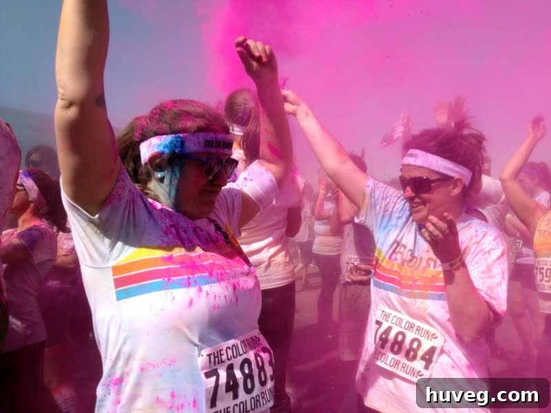 Aerial view of participants engulfed in a massive cloud of colorful powder, a truly immersive experience.