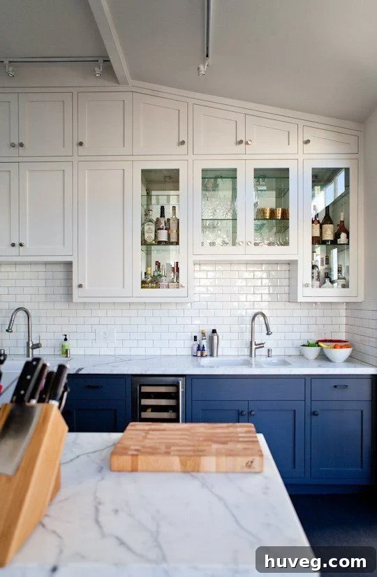 Navy blue lower kitchen cabinets with white uppers.