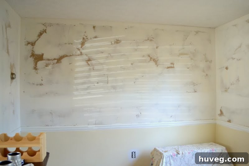 Dining room with skim-coated walls, ready for paint.