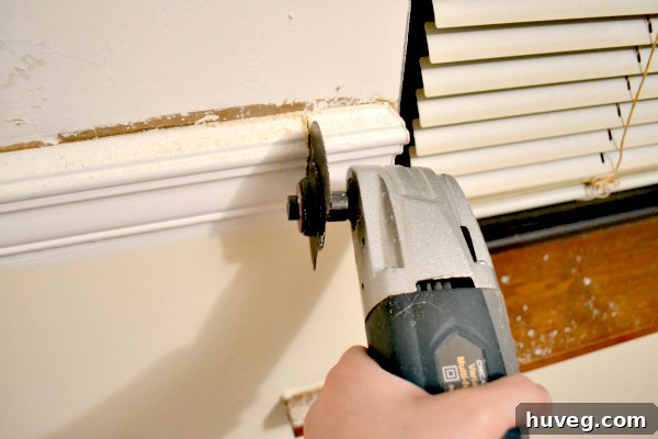Using an oscillating tool to cut through chair rail