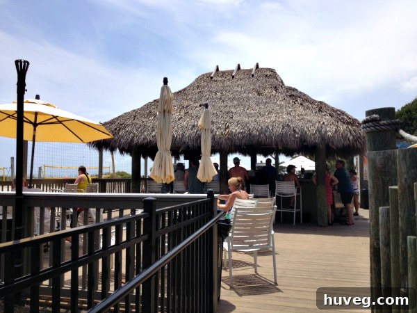 Two people enjoying a casual conversation at a tiki bar