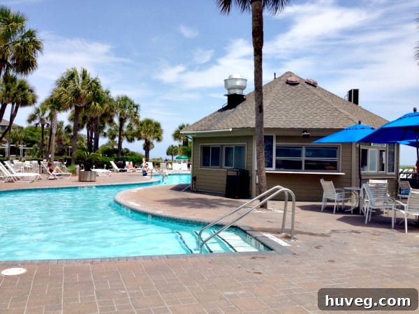 Person on video call by the pool, connecting with friends while traveling