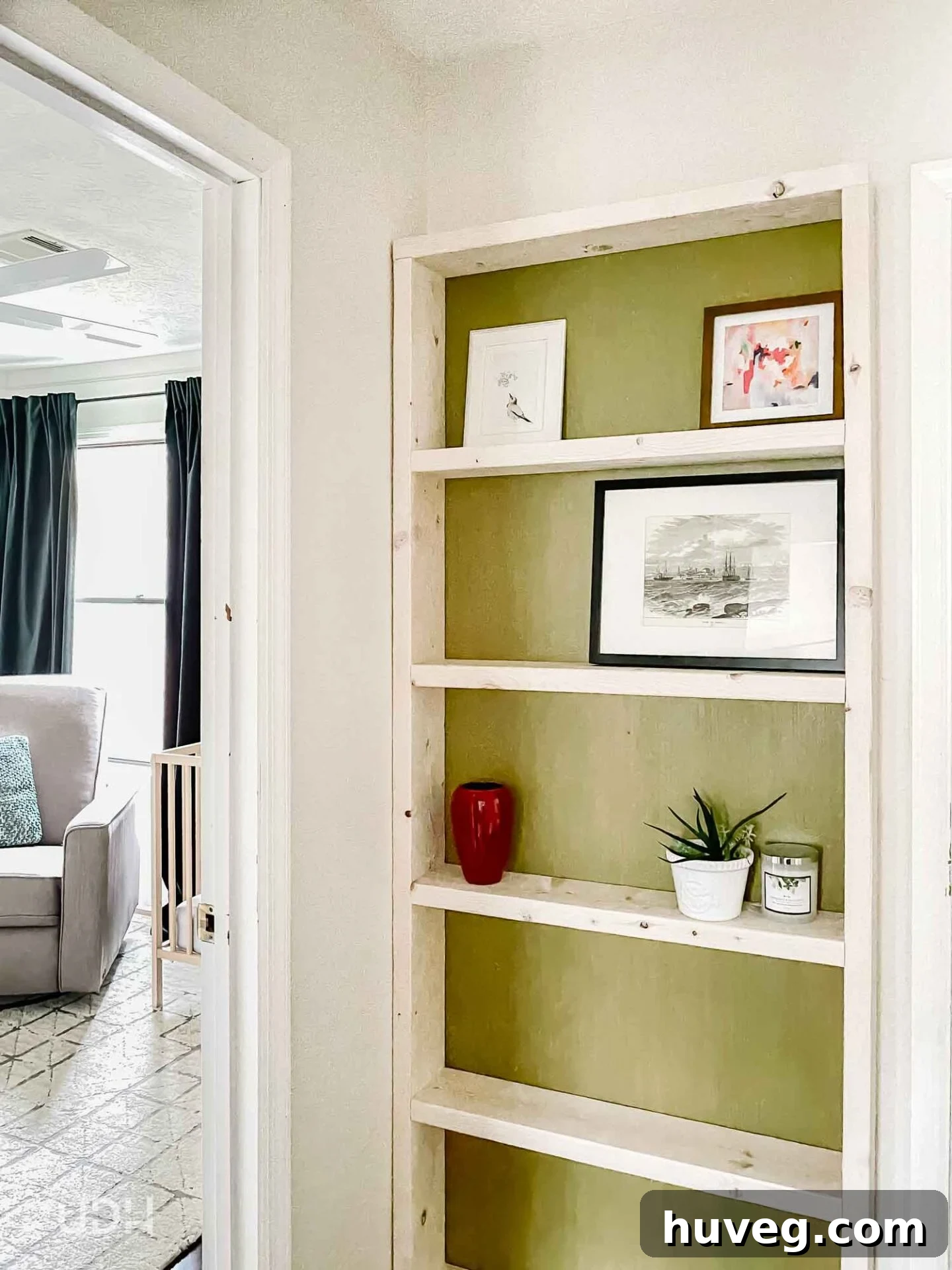 Narrow DIY floating bookcase in a hallway, offering stylish storage without occupying floor space. Features a vibrant green backer.