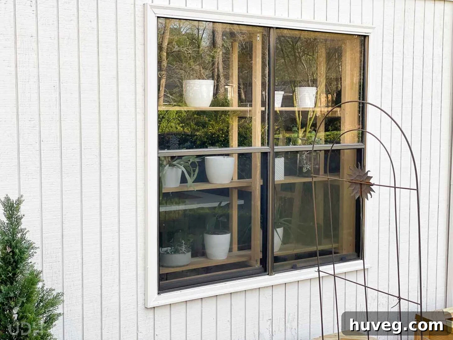 view from back yard looking into the house at the new DIY window plant shelves, showcasing outdoor appeal
