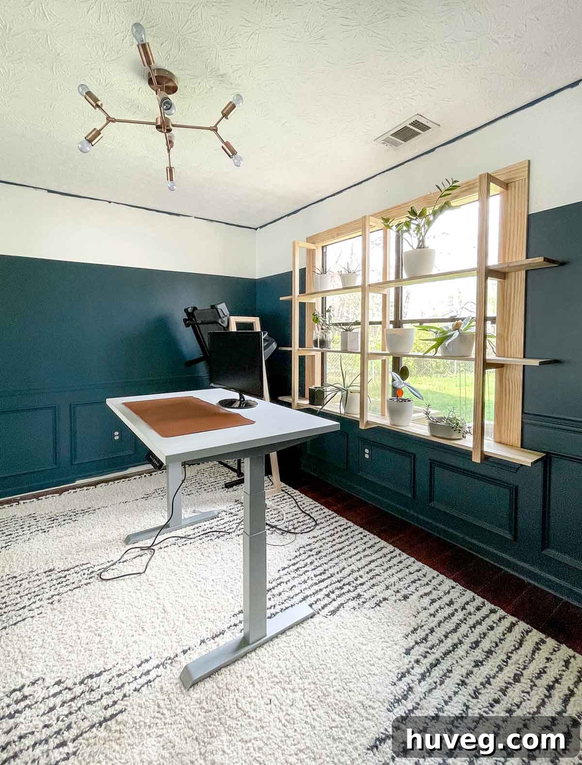view of empty new office with standing adjustable height desk and newly installed window plant shelves