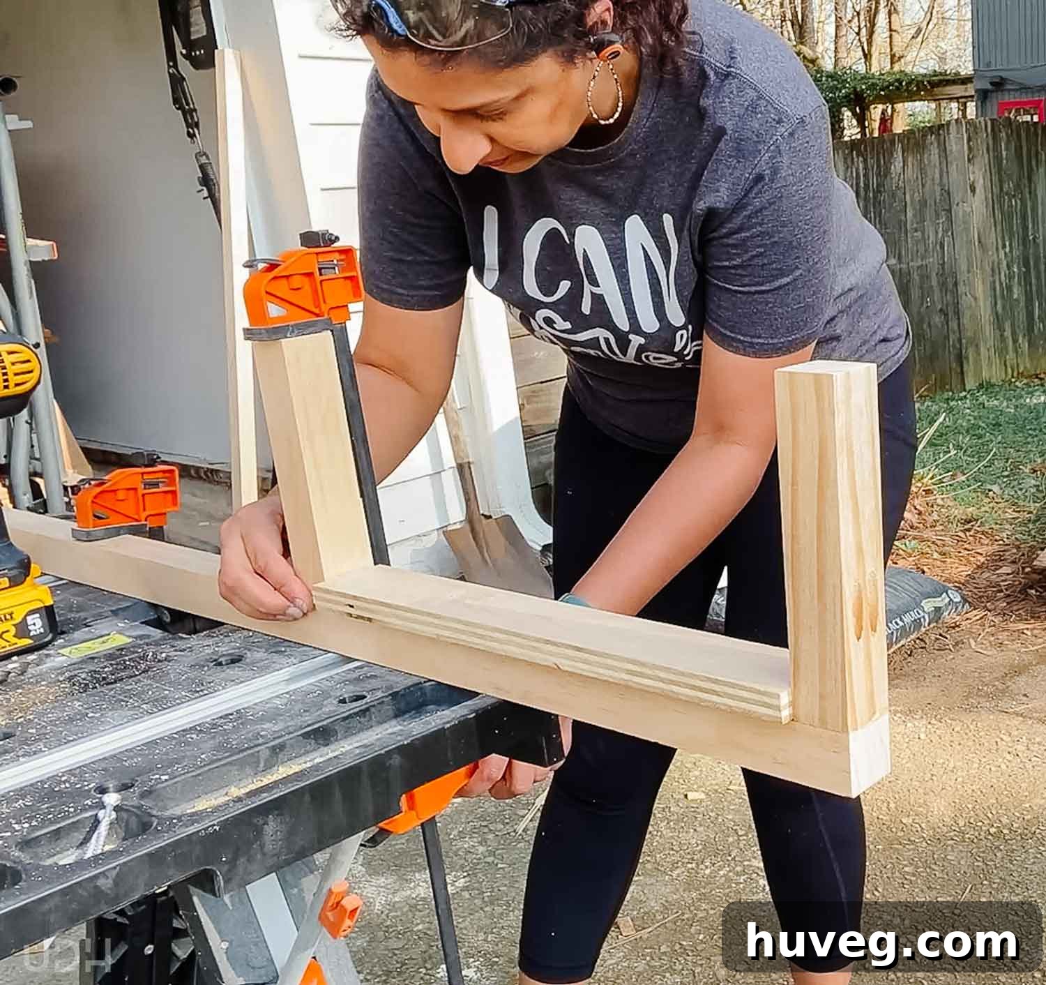 Anika expertly assembling the shelf supports on a portable WORX table