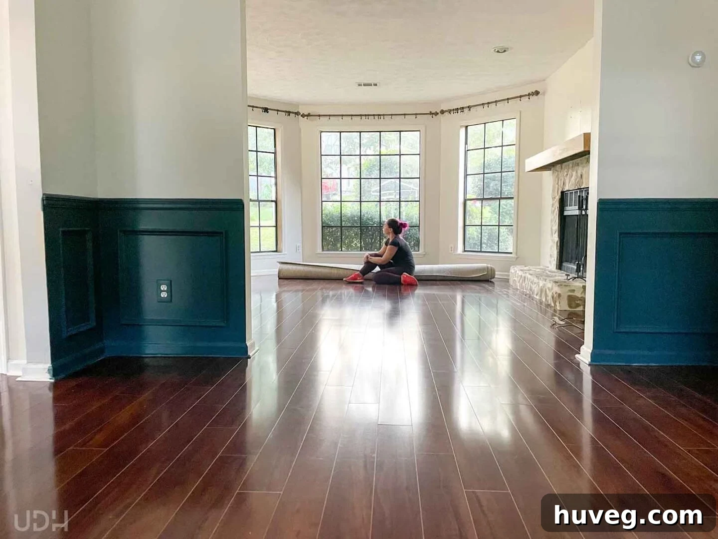 me sitting on our rolled up living room rug after moving out all of my things and reflecting on big changes