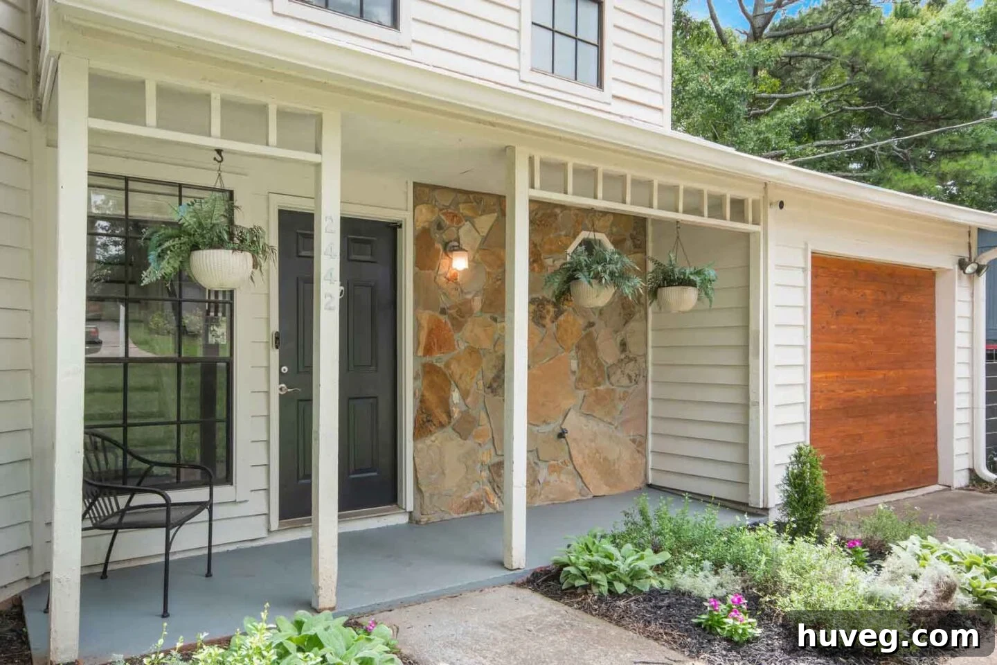 front porch view with new garden bed and stone facade
