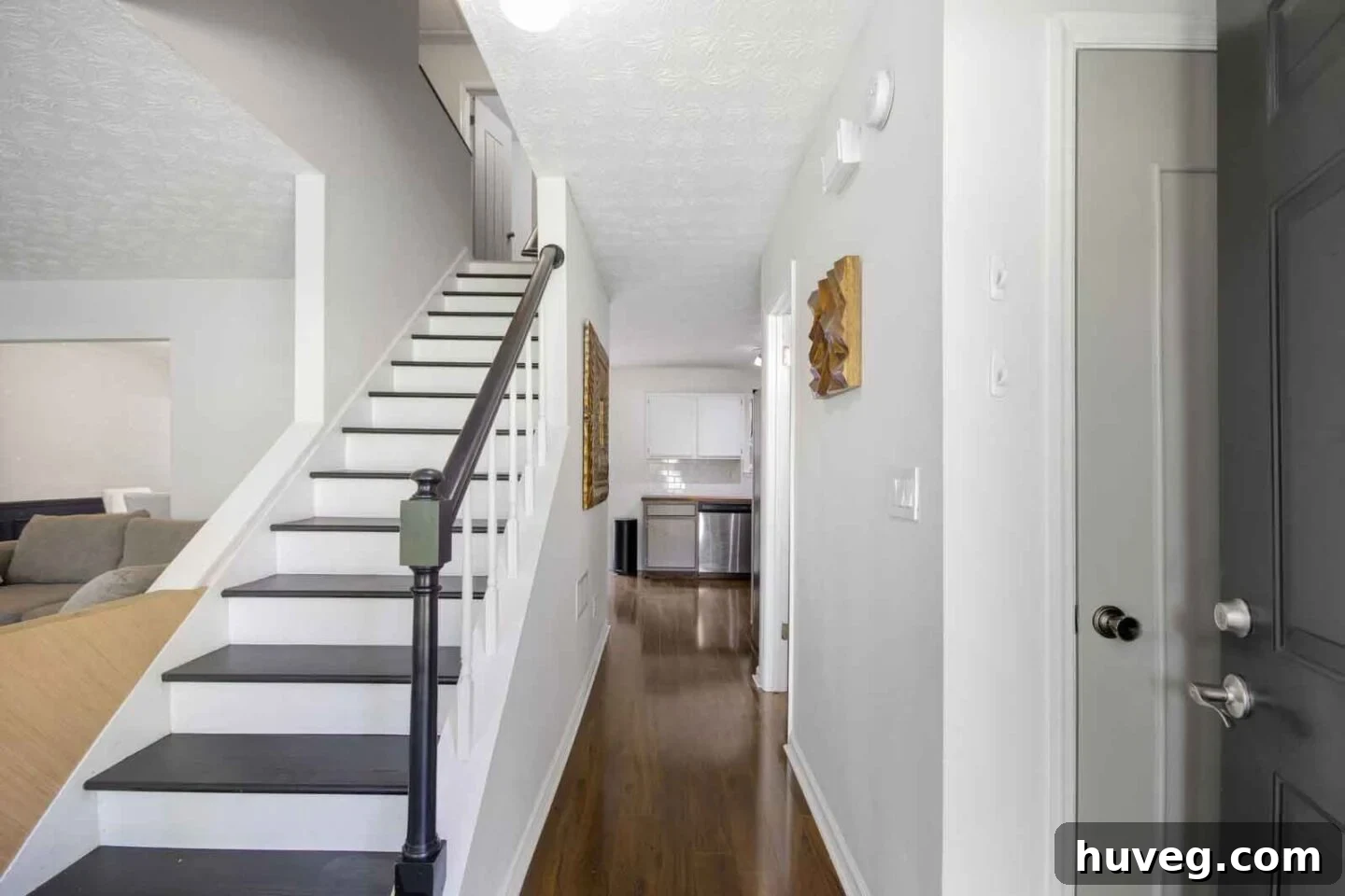 entryway hall view with black and white stairs