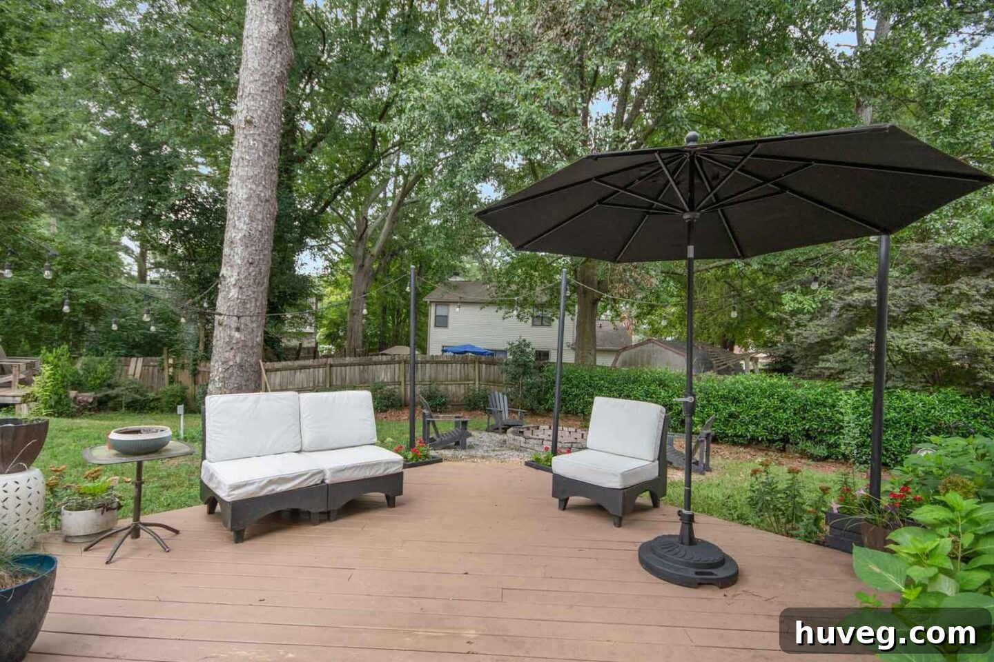 back yard floating deck with black umbrella
