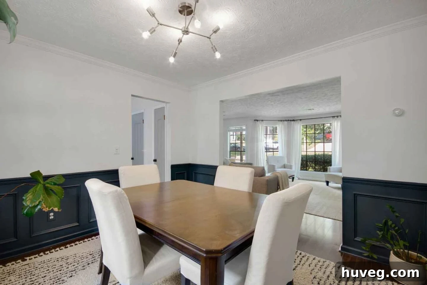 dining room with lower dark gray teal half painted walls