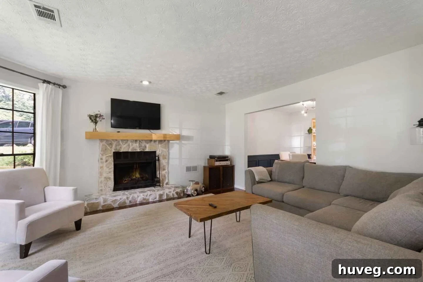 living room with gray sectional DIY coffee table and German smear fireplace