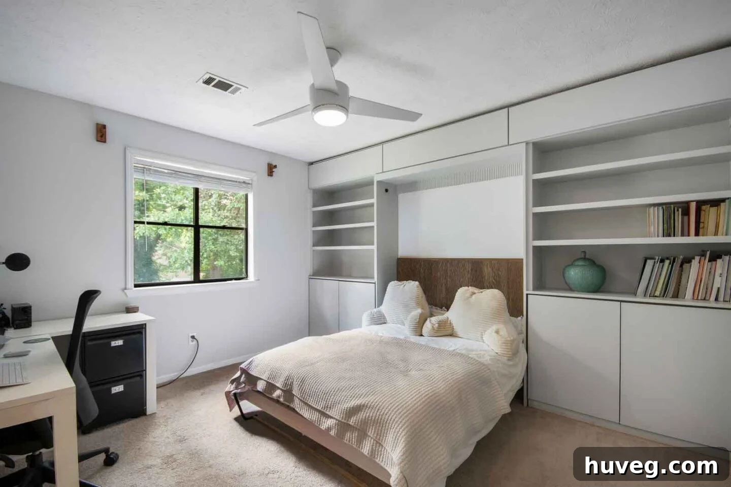 guest bedroom with light gray built in cabinets and Murphy bed