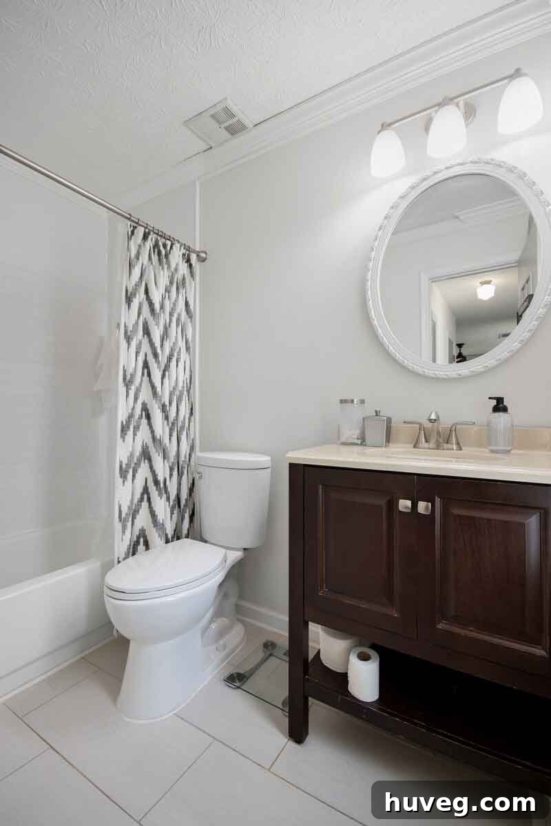 primary bathroom white tile and dark vanity