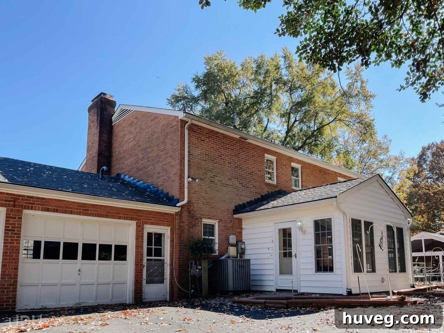 The rear view of a beautiful brick colonial home with a sunroom, a property we admired during our Richmond house hunt but ultimately passed on.
