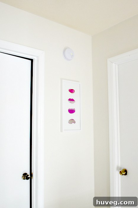 Striking pink agate slice wall art adds a vibrant focal point to the home interior.