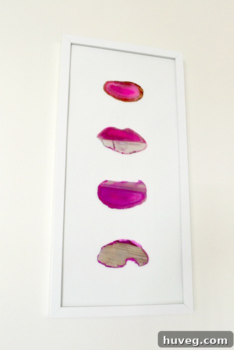 The newly installed pink agate slice wall art, perfectly level and enhancing the hallway decor.