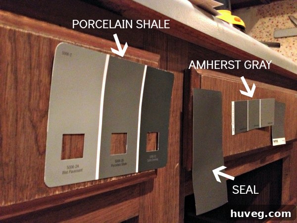 Three paint swatches labeled with names: Valspar's Porcelain Shale, Martha Stewart's Seal, and Benjamin Moore's Amherst Gray