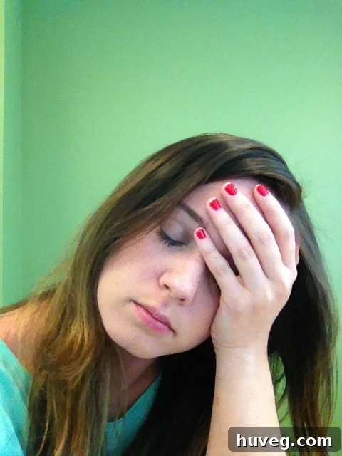 Sarah with her hand on her head, looking thoughtful, potentially exhibiting BRF