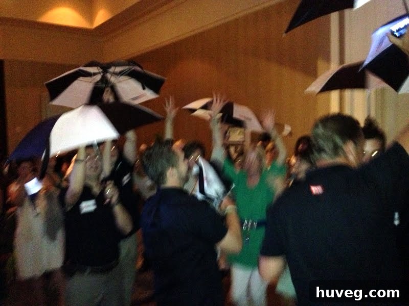 Ryobi tool representatives dancing with branded umbrellas at the Haven Conference party