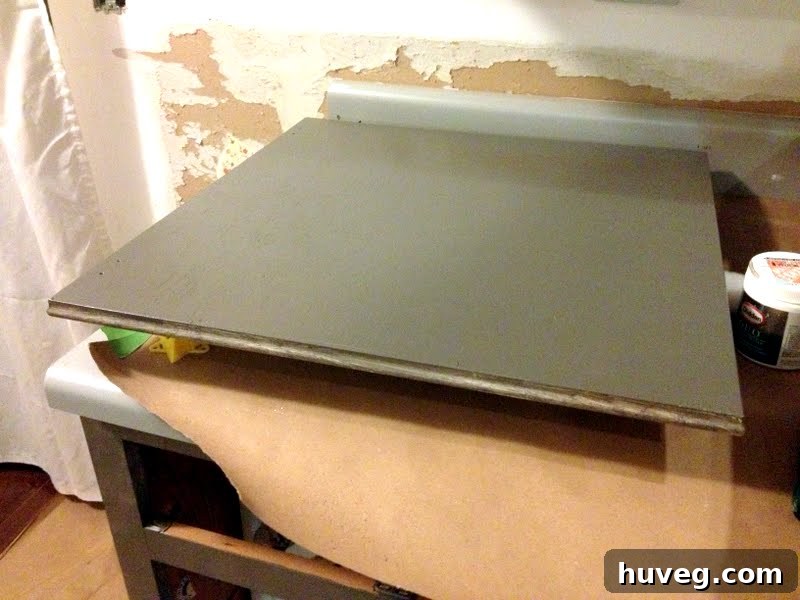 Second coat of Benjamin Moore Advance paint applied to kitchen cabinet doors for a smooth finish