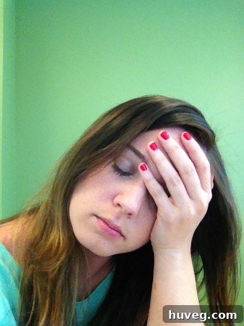 Woman with a headache, symbolizing worry and renovation stress