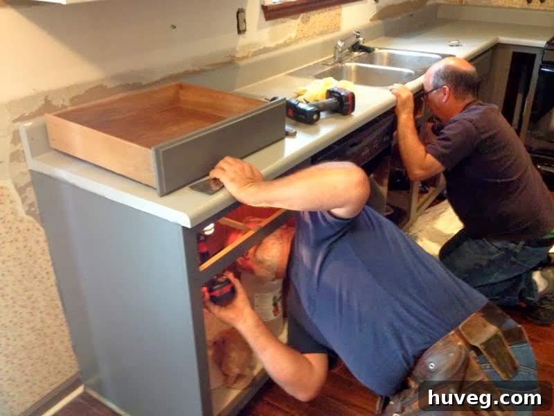 Removing old kitchen countertops, showing renovation in progress