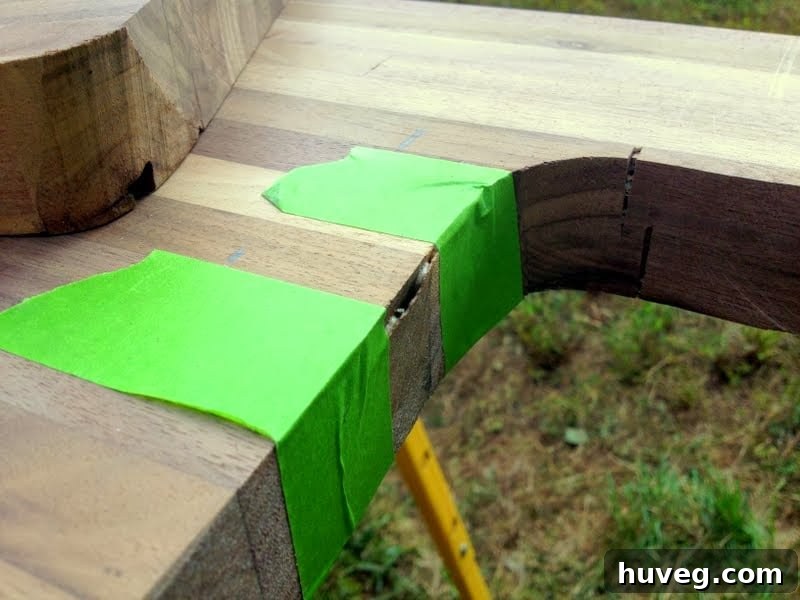 Securing wood repair with tape and clamps on butcher block
