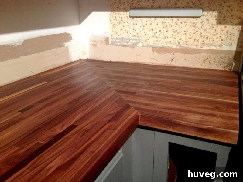 Richly colored walnut butcher block after being treated with mineral oil and beeswax, showing a significant transformation.
