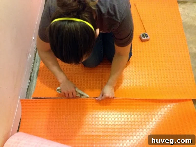 Installing Ditra uncoupling membrane over concrete subfloor