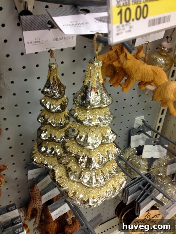 Several festive ornaments showcasing the silver-gold blend, possibly displayed on a shelf or against a holiday backdrop, highlighting their subtle shimmer.