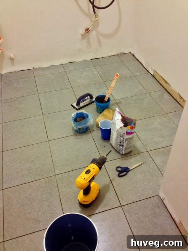 Before shot of a messy laundry room area, possibly with bare walls or unfinished work, showcasing the need for renovation.