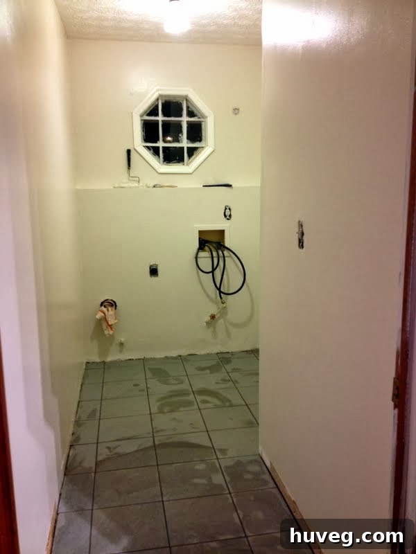 Finished laundry room floor with new grout, showing the clean lines and completed tiling project.