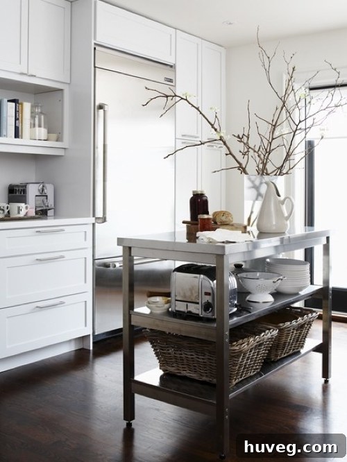 White Kitchen 1 - An inspiring image of a modern white kitchen featuring an industrial-style prep table island.