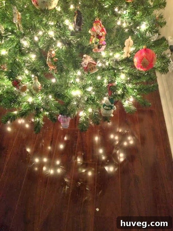 A close-up shot of Christmas tree lights twinkling and reflecting on a polished wooden floor, creating a magical ambiance.