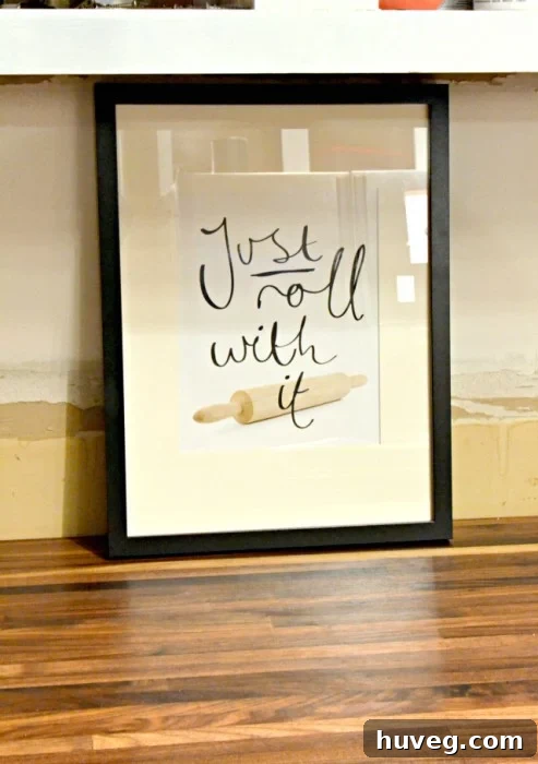 Humorous 'Just Roll With It' rolling pin kitchen print, perfect for inspiring a relaxed approach to cooking and adding personality to kitchen decor.