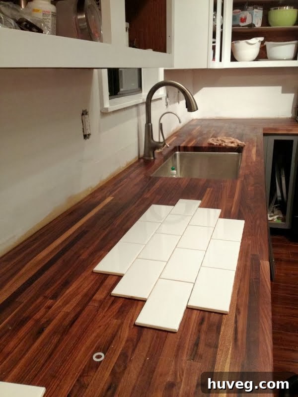 Laying out tile pattern on kitchen counter to plan backsplash installation