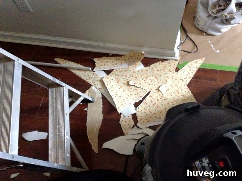 Piles of old wallpaper on the floor, signifying completion of removal