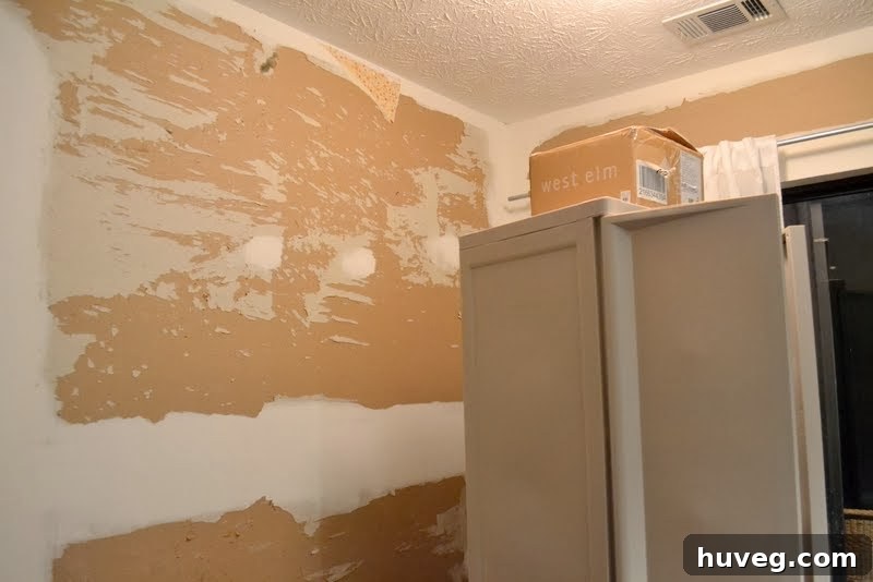 Mom enthusiastically helping peel stubborn wallpaper in the kitchen