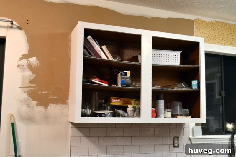 Kitchen walls after all wallpaper is removed, showing areas needing skim coating