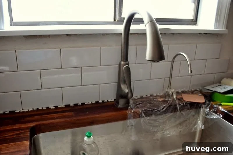 Tiling around kitchen windows and faucets with precision