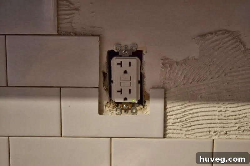 Detail of tile cuts around an electrical outlet