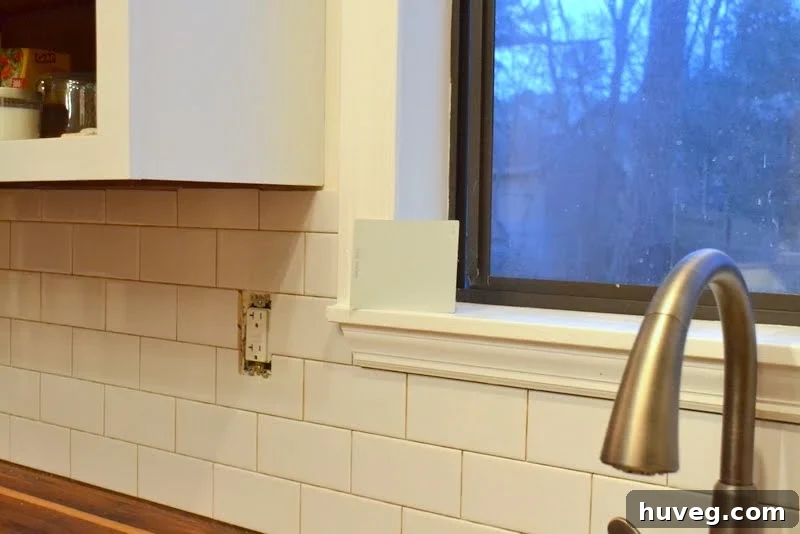 Assessing the unique window ledge and tile depth for a kitchen backsplash project