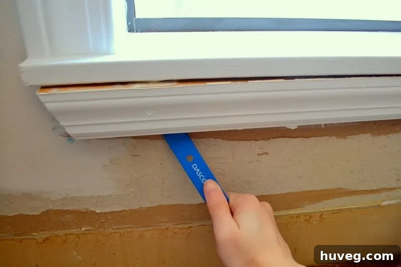 Carefully prying off existing window molding for kitchen backsplash tiling