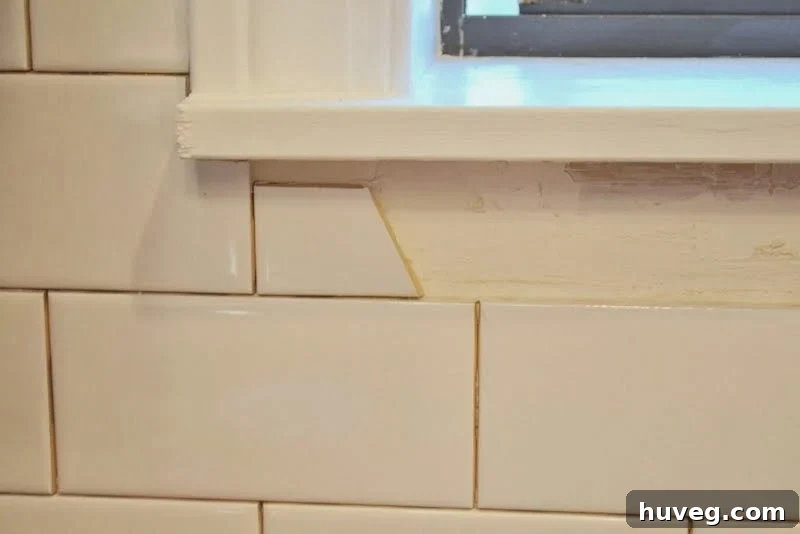 Filling in awkward spaces with small tile pieces under future window molding