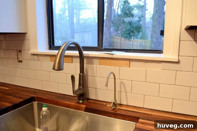Adding wood shims to match tile depth for flush window molding reinstallation