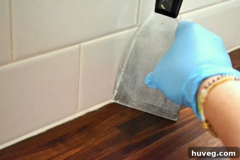 Use a putty knife to clean excess caulk