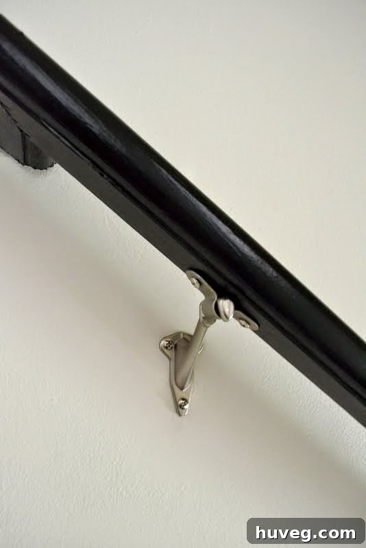 Handrail temporarily resting on wall-mounted brackets using the slip-on method, ready for final tightening